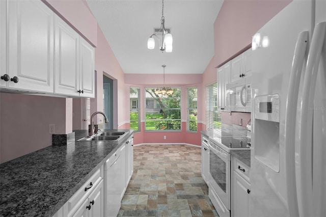 7445 Nature Walk Dr, Spring Hill, FL 34606 - kitchen featuring white appliances, a chandelier, lofted ceiling, white cabinets, and hanging light fixtures