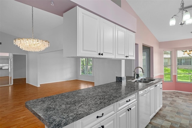 7445 Nature Walk Dr, Spring Hill, FL 34606 - kitchen featuring a chandelier, white dishwasher, lofted ceiling, white cabinets, and plenty of natural light