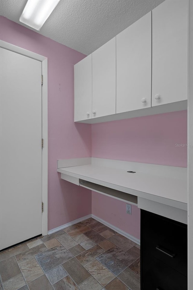 7445 Nature Walk Dr, Spring Hill, FL 34606 - unfurnished office featuring stone finish floors and a textured ceiling