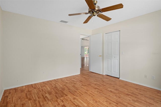 7445 Nature Walk Dr, Spring Hill, FL 34606 - unfurnished bedroom with light wood-type flooring, a ceiling fan, and a closet