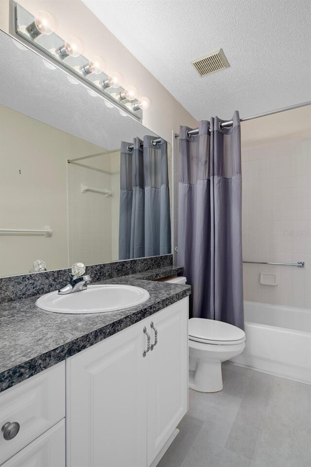 7445 Nature Walk Dr, Spring Hill, FL 34606 - bathroom with vanity, a textured ceiling, and shower / tub combo