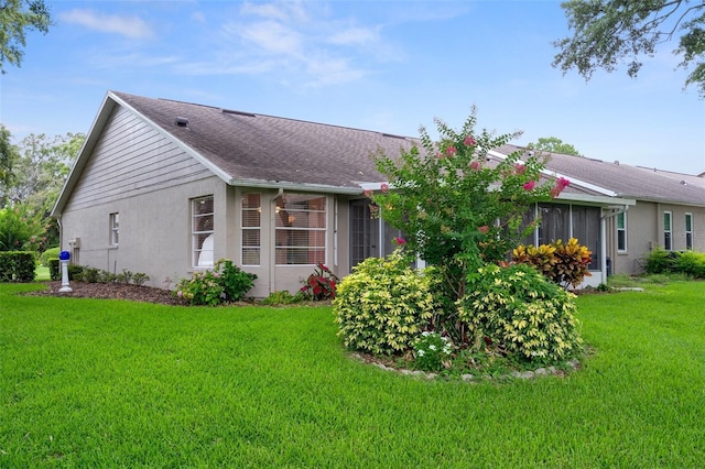 7445 Nature Walk Dr, Spring Hill, FL 34606 - view of home's exterior featuring a yard and stucco siding