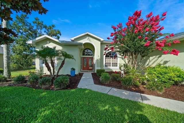 14178 Pullman Dr, Spring Hill, FL 34609 - view of front of home with stucco siding and a front yard