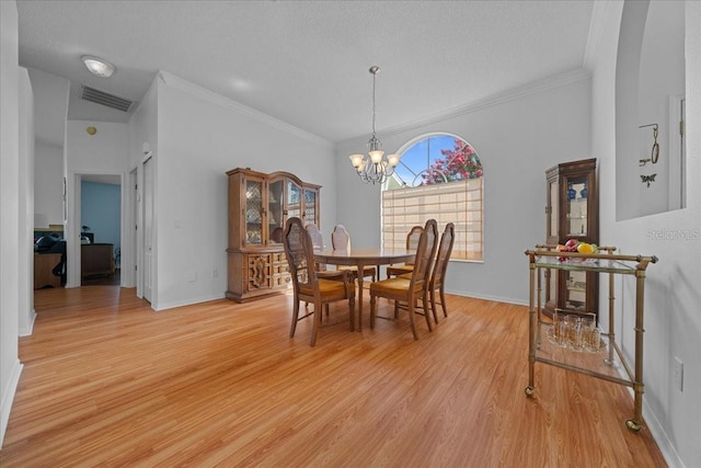 14178 Pullman Dr, Spring Hill, FL 34609 - dining room featuring ornamental molding, a chandelier, and light wood-style floors