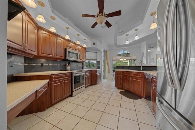 14178 Pullman Dr, Spring Hill, FL 34609 - kitchen with stainless steel appliances, light tile patterned floors, a ceiling fan, tasteful backsplash, and light countertops