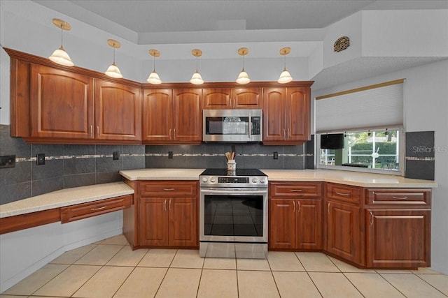 14178 Pullman Dr, Spring Hill, FL 34609 - kitchen featuring appliances with stainless steel finishes, tasteful backsplash, light countertops, decorative light fixtures, and light tile patterned floors