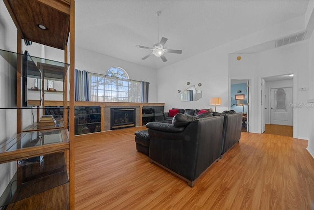 14178 Pullman Dr, Spring Hill, FL 34609 - living room featuring light wood-style floors, ceiling fan, and a fireplace