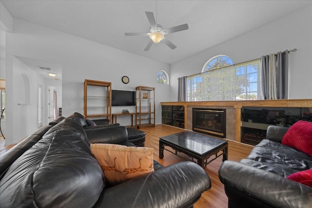 14178 Pullman Dr, Spring Hill, FL 34609 - living area featuring wood finished floors, a ceiling fan, and a glass covered fireplace