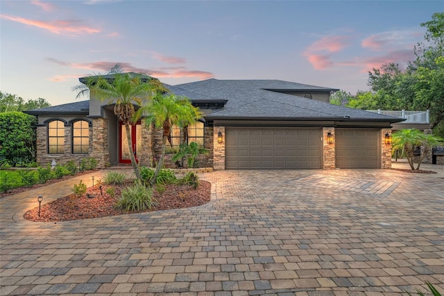 26221 Pheasant Run, Wesley Chapel, FL 33544 - view of front facade with decorative driveway, stone siding, and an attached garage