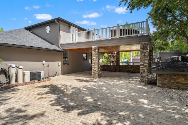 26221 Pheasant Run, Wesley Chapel, FL 33544 - rear view of property with stucco siding, roof with shingles, stairway, and a wooden deck