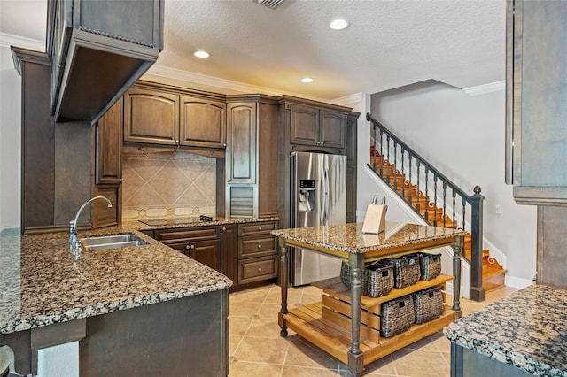 26221 Pheasant Run, Wesley Chapel, FL 33544 - kitchen with stainless steel fridge with ice dispenser, crown molding, light stone countertops, tasteful backsplash, and light tile patterned floors