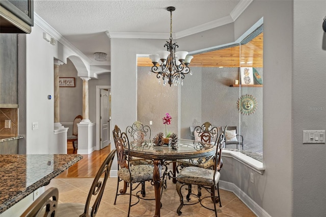 26221 Pheasant Run, Wesley Chapel, FL 33544 - tiled dining area featuring decorative columns, ornamental molding, arched walkways, and a chandelier