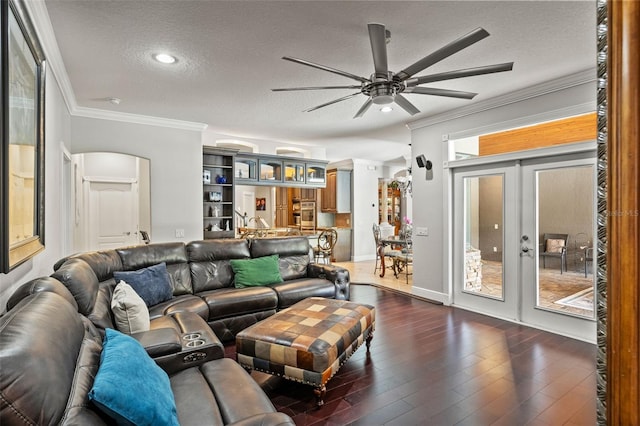 26221 Pheasant Run, Wesley Chapel, FL 33544 - living area featuring ornamental molding, a ceiling fan, a textured ceiling, french doors, and dark wood-type flooring