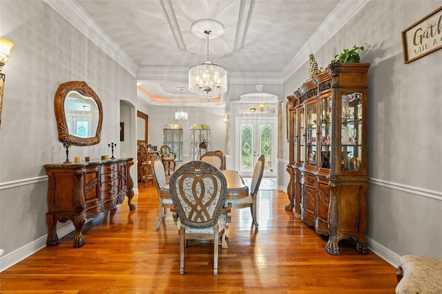 26221 Pheasant Run, Wesley Chapel, FL 33544 - dining area featuring a chandelier, wood finished floors, crown molding, and arched walkways