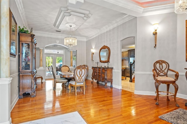 26221 Pheasant Run, Wesley Chapel, FL 33544 - dining room with french doors, arched walkways, a chandelier, light wood-type flooring, and ornamental molding