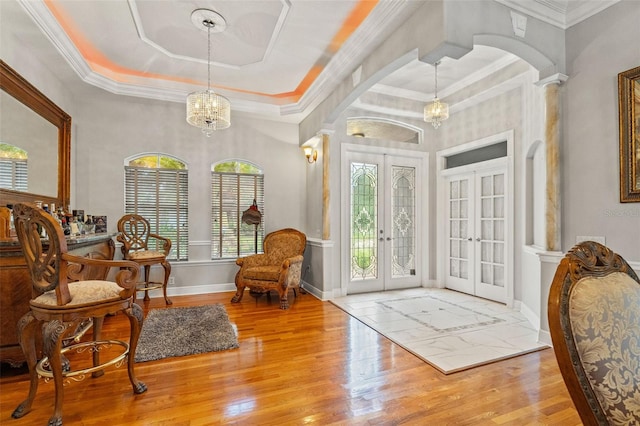26221 Pheasant Run, Wesley Chapel, FL 33544 - entryway with french doors, plenty of natural light, a chandelier, wood finished floors, and crown molding