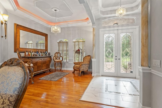 26221 Pheasant Run, Wesley Chapel, FL 33544 - entryway featuring a tray ceiling, french doors, a chandelier, wood finished floors, and crown molding