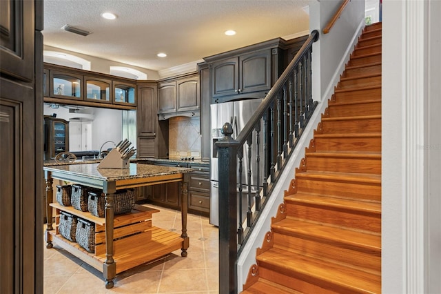 26221 Pheasant Run, Wesley Chapel, FL 33544 - stairway featuring tile patterned flooring, recessed lighting, and a textured ceiling