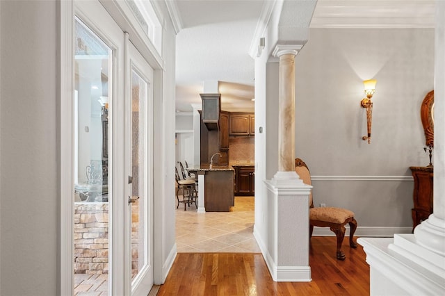 26221 Pheasant Run, Wesley Chapel, FL 33544 - hall featuring ornate columns, ornamental molding, and light wood finished floors