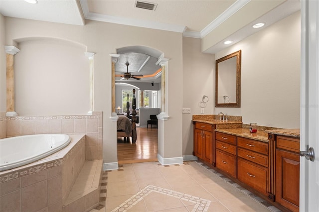 26221 Pheasant Run, Wesley Chapel, FL 33544 - bathroom featuring crown molding, a garden tub, vanity, tile patterned flooring, and ornate columns