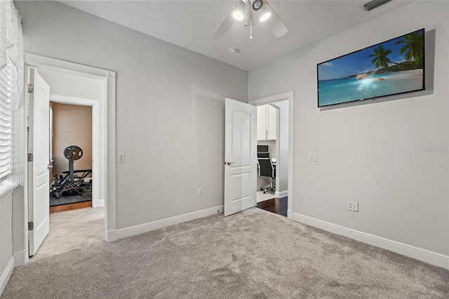 26221 Pheasant Run, Wesley Chapel, FL 33544 - unfurnished bedroom featuring carpet flooring and a ceiling fan
