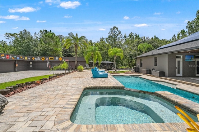 26221 Pheasant Run, Wesley Chapel, FL 33544 - view of pool with a patio area, view of wooded area, and a pool with connected hot tub