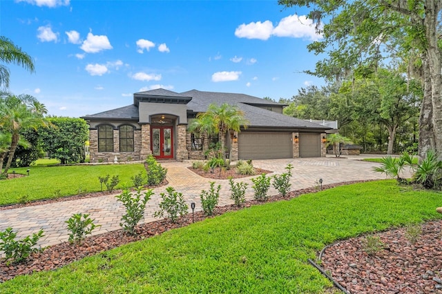 26221 Pheasant Run, Wesley Chapel, FL 33544 - view of front facade featuring an attached garage, decorative driveway, stone siding, a front yard, and roof with shingles