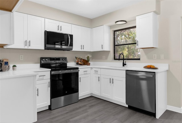 5215 Azalea Cir, Dade City, FL 33523 - kitchen featuring appliances with stainless steel finishes, white cabinetry, and light wood-style flooring