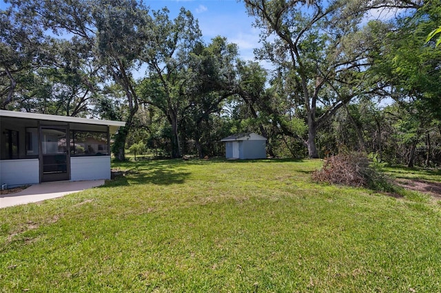 5215 Azalea Cir, Dade City, FL 33523 - view of green lawn featuring a sunroom and a storage shed