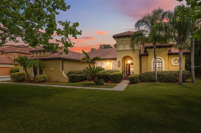 9829 Sorbonne Loop, Seffner, FL 33584 - mediterranean / spanish-style home with stucco siding, a yard, and a tiled roof