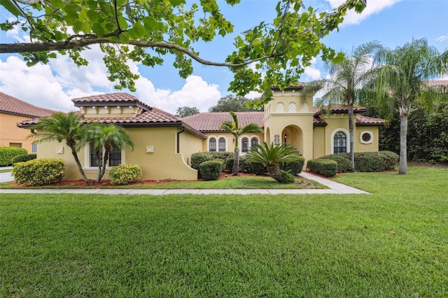 9829 Sorbonne Loop, Seffner, FL 33584 - mediterranean / spanish house with stucco siding, a tile roof, and a front lawn