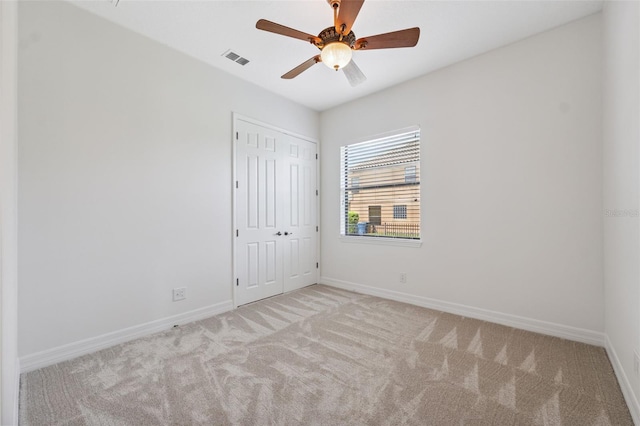 9829 Sorbonne Loop, Seffner, FL 33584 - unfurnished bedroom with carpet flooring, a closet, and a ceiling fan