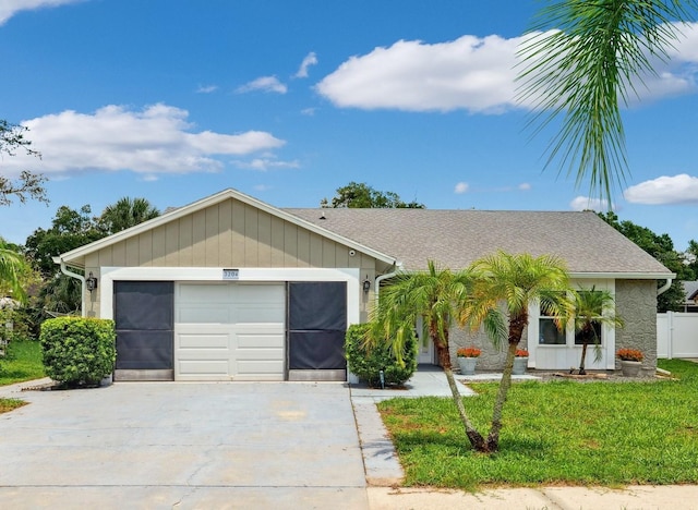 3204 Payne St, New Port Richey, FL 34655 - ranch-style home featuring driveway, a garage, a front lawn, and stone siding