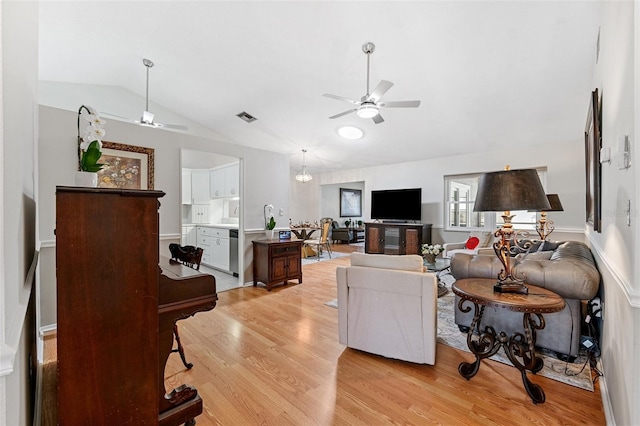 3204 Payne St, New Port Richey, FL 34655 - living area featuring a ceiling fan, vaulted ceiling, and light wood finished floors