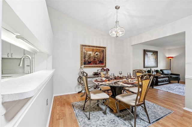 3204 Payne St, New Port Richey, FL 34655 - dining space featuring light wood-type flooring and a chandelier
