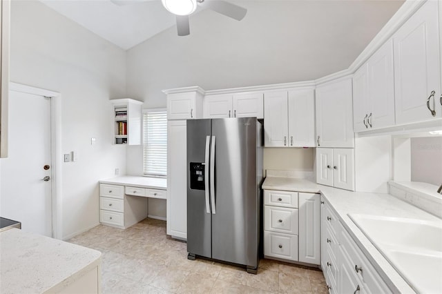 3204 Payne St, New Port Richey, FL 34655 - kitchen with stainless steel fridge with ice dispenser, a ceiling fan, white cabinetry, vaulted ceiling, and light countertops