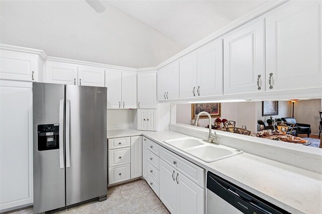 3204 Payne St, New Port Richey, FL 34655 - kitchen featuring stainless steel refrigerator with ice dispenser, lofted ceiling, light countertops, dishwasher, and white cabinets