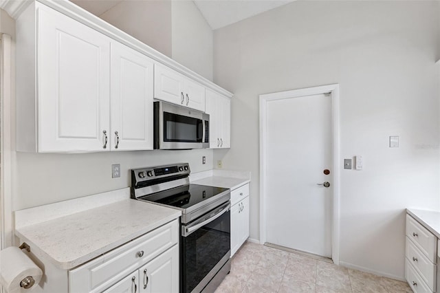 3204 Payne St, New Port Richey, FL 34655 - kitchen with appliances with stainless steel finishes, light countertops, and white cabinetry