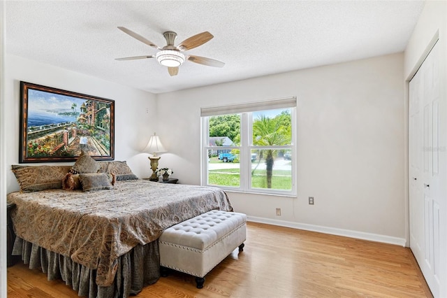 3204 Payne St, New Port Richey, FL 34655 - bedroom with wood finished floors, a textured ceiling, a closet, and a ceiling fan