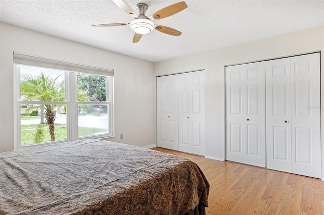 3204 Payne St, New Port Richey, FL 34655 - bedroom featuring light wood-style flooring, multiple closets, a textured ceiling, and a ceiling fan