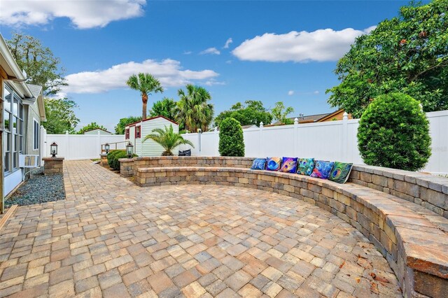 3204 Payne St, New Port Richey, FL 34655 - fenced backyard featuring a patio area, an outdoor structure, and cooling unit