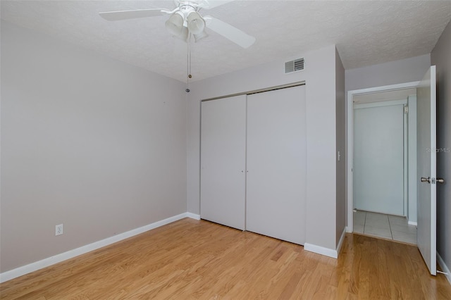 5640 Ferguson Ct Unit 2203, New Port Richey, FL 34652 - unfurnished bedroom with light wood-type flooring, a closet, and a ceiling fan