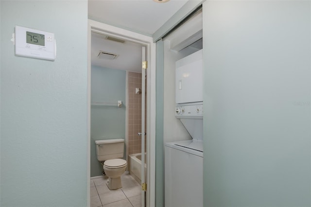 5640 Ferguson Ct Unit 2203, New Port Richey, FL 34652 - full bathroom with stacked washing machine and dryer, tile patterned flooring, and tub / shower combination