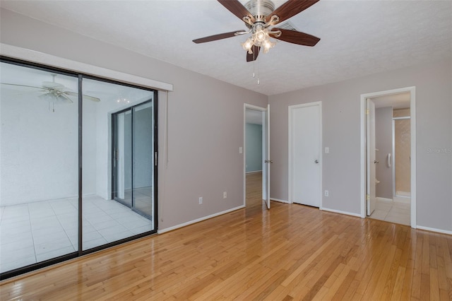 5640 Ferguson Ct Unit 2203, New Port Richey, FL 34652 - unfurnished bedroom featuring light wood-style flooring, access to outside, ensuite bathroom, and a ceiling fan