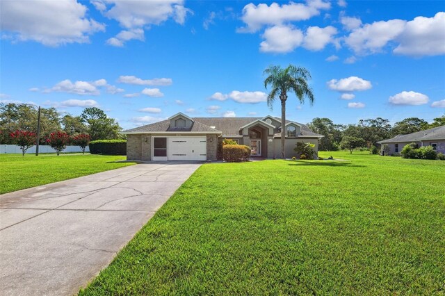 1478 Brigadier Dr, Spring Hill, FL 34608 - view of front of home with an attached garage, a front yard, concrete driveway, and brick siding