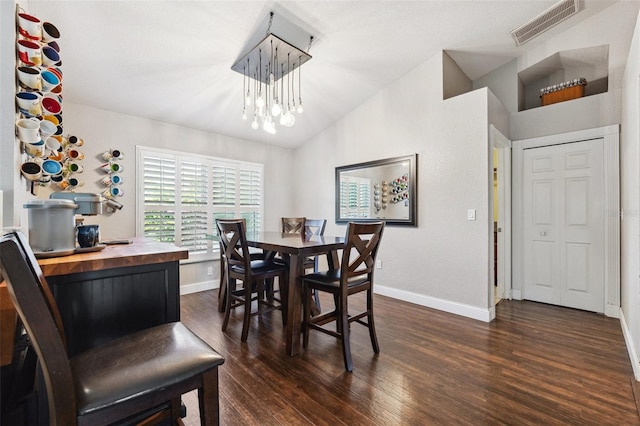 1478 Brigadier Dr, Spring Hill, FL 34608 - dining area featuring dark wood-type flooring, vaulted ceiling, and a chandelier