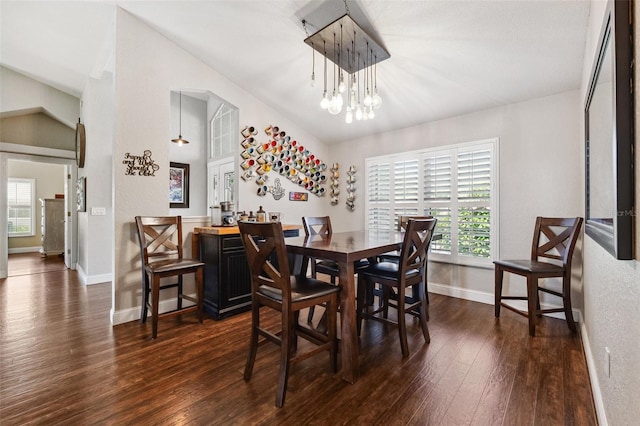 1478 Brigadier Dr, Spring Hill, FL 34608 - dining space featuring dark wood-type flooring, healthy amount of natural light, a chandelier, and vaulted ceiling