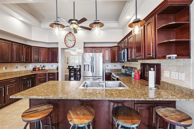 1478 Brigadier Dr, Spring Hill, FL 34608 - kitchen with appliances with stainless steel finishes, a peninsula, a tray ceiling, tasteful backsplash, and a towering ceiling