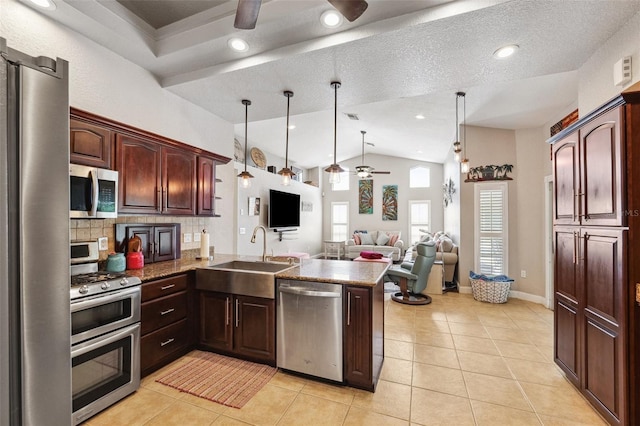 1478 Brigadier Dr, Spring Hill, FL 34608 - kitchen featuring stainless steel appliances, a ceiling fan, a peninsula, lofted ceiling, and open floor plan