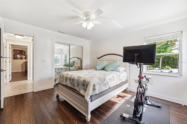 1478 Brigadier Dr, Spring Hill, FL 34608 - bedroom featuring multiple windows, dark wood-type flooring, a closet, crown molding, and ceiling fan